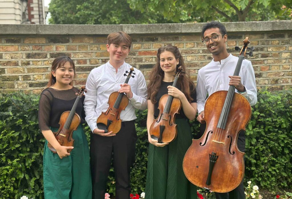 The Isla Quartet posing with their string instruments for a promotional photo