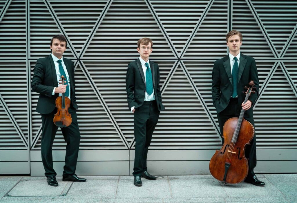 The Mithras Trio members posing for a professional ensemble photo